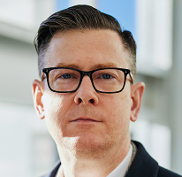 Ritratto di Alexander Hughes executive e CEO di un'azienda di trading crypto